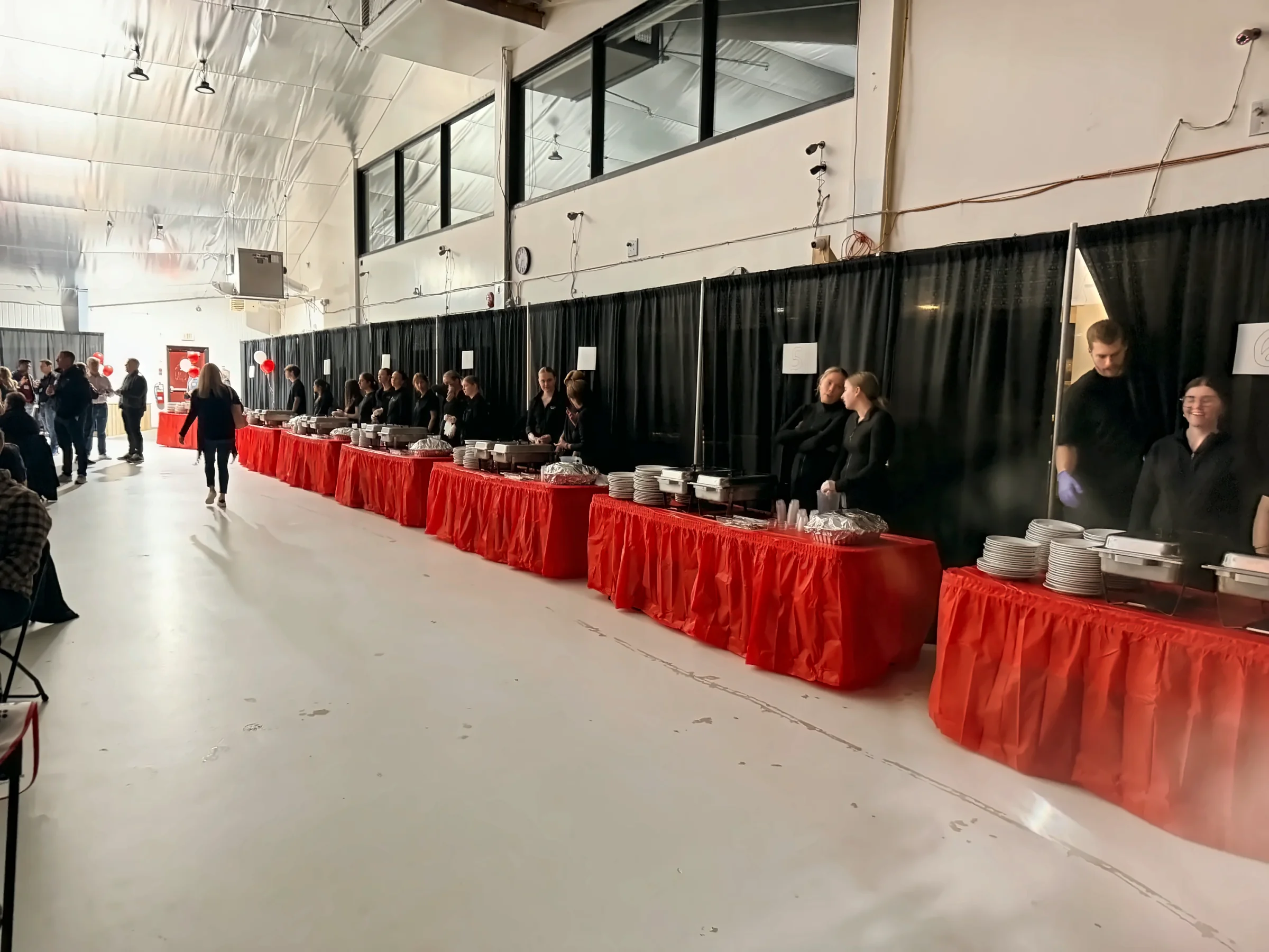 Fireside Catering staff serving a long buffet line at a large catered event
